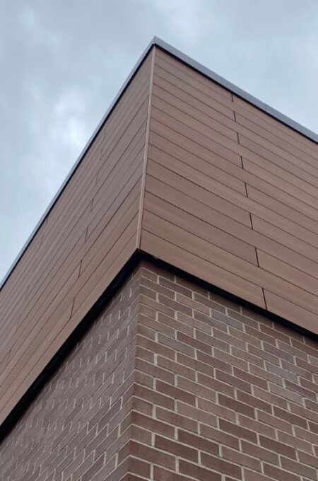 Romantic Walnut and Dark Green Trespa finishes on the Spectrum Facades, showcasing the superior craftsmanship at LL Bean – Tuscan Village