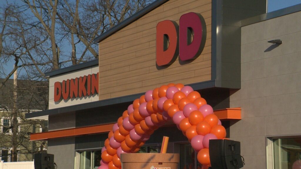 Close-up of Trespa Pura NFC PU02 Classic Oak finish on Spectrum Facades at Dunkin Donuts