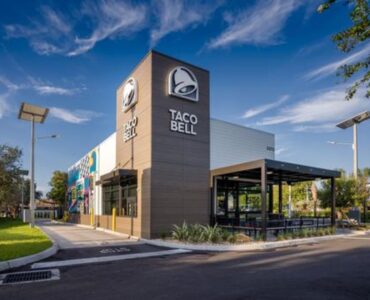 An exterior view of the Taco Bell building featuring a French Walnut finish